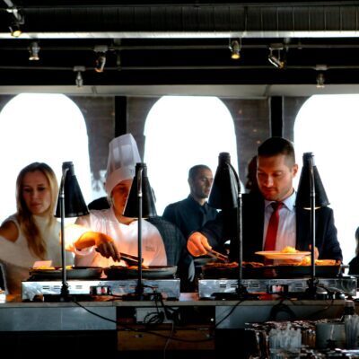 Business professionals enjoying a buffet meal in a contemporary indoor restaurant setting.
