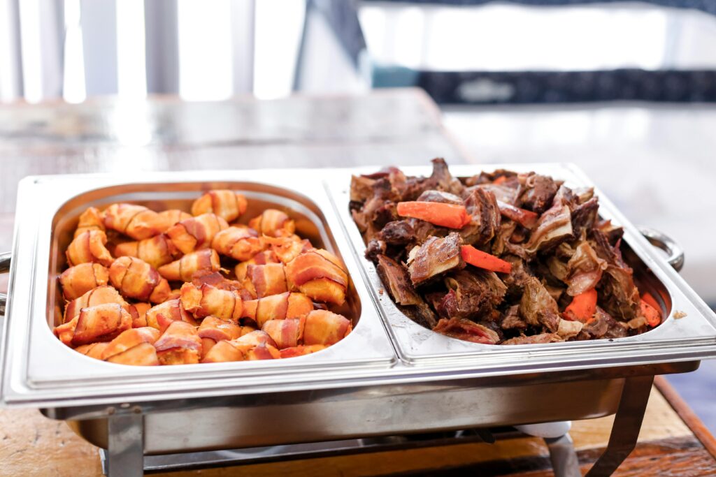 Delicious buffet with bacon wrapped potatoes and roast beef, perfect for any meal.