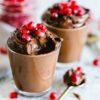 Luscious chocolate mousse topped with fresh pomegranate seeds, perfect for dessert lovers.