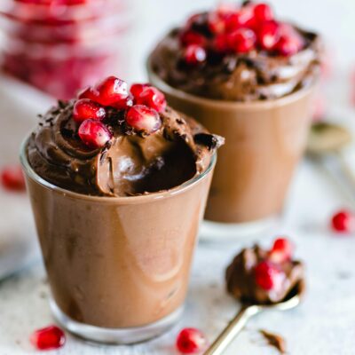 Luscious chocolate mousse topped with fresh pomegranate seeds, perfect for dessert lovers.